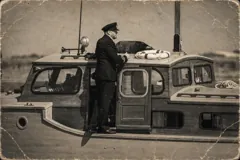 On deck beside the wheelhouse — sepia photograph