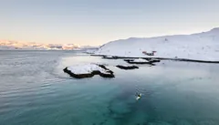 Paddling along a snow-covered Arctic coastline — March 2023