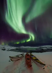 Kayaks beneath the northern lights